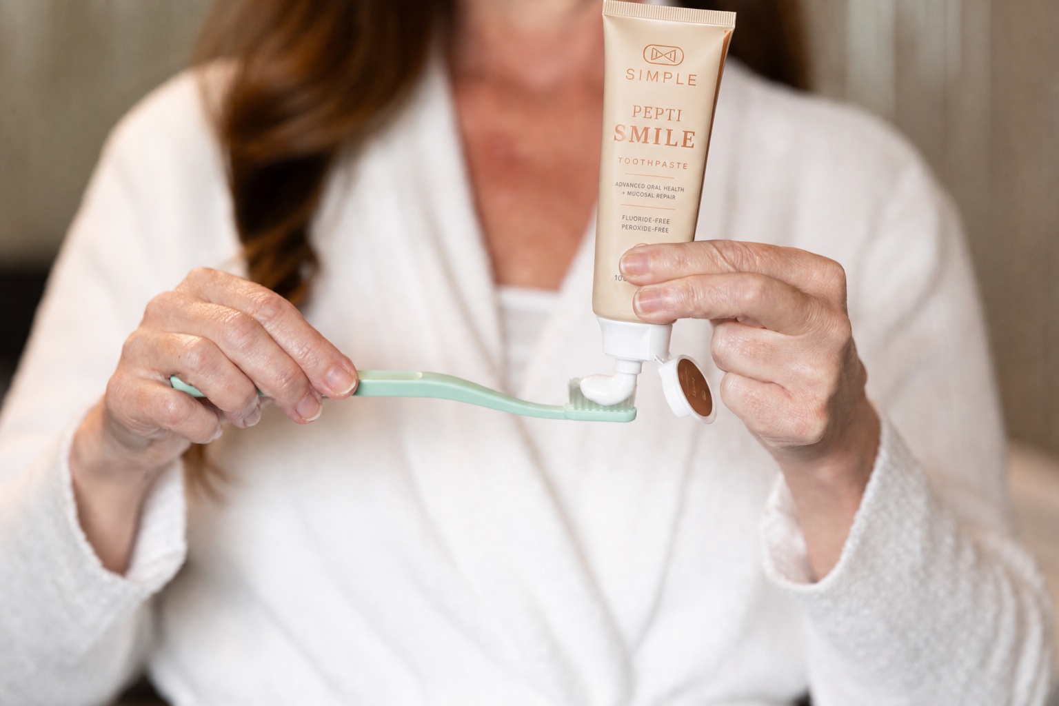 PeptiSmile peptide toothpaste being applied to a toothbrush